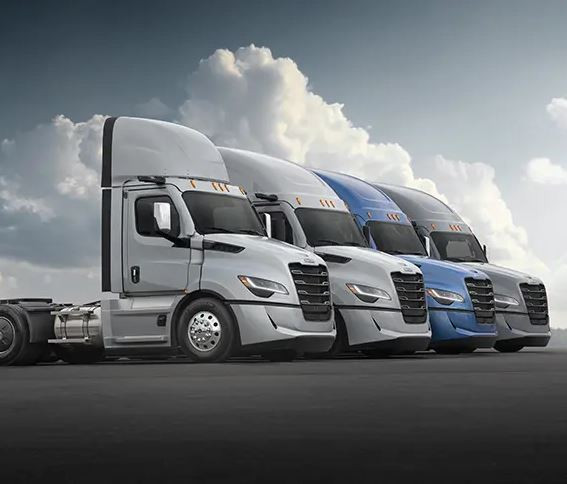 Right side view of four cascadia freightliners parked in a row.