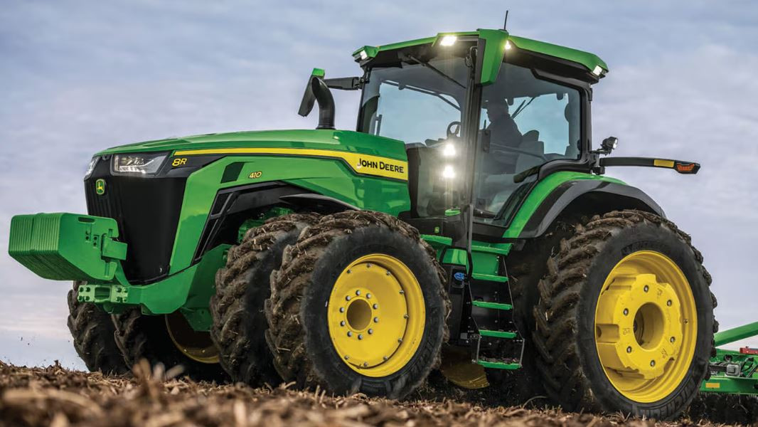 John Deere 8R left side view in a field setting.