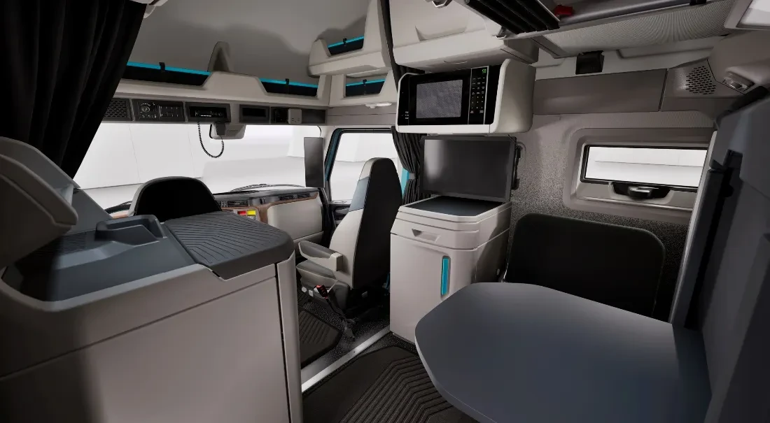 Interior view from the back of a Volvo bunk showing the back side of the front driver and passenger seats.